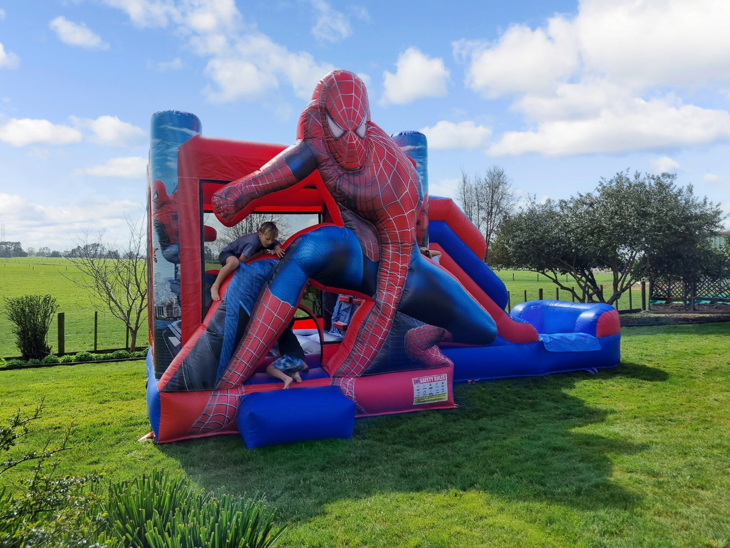 Spidey Inflatable Castle on grass